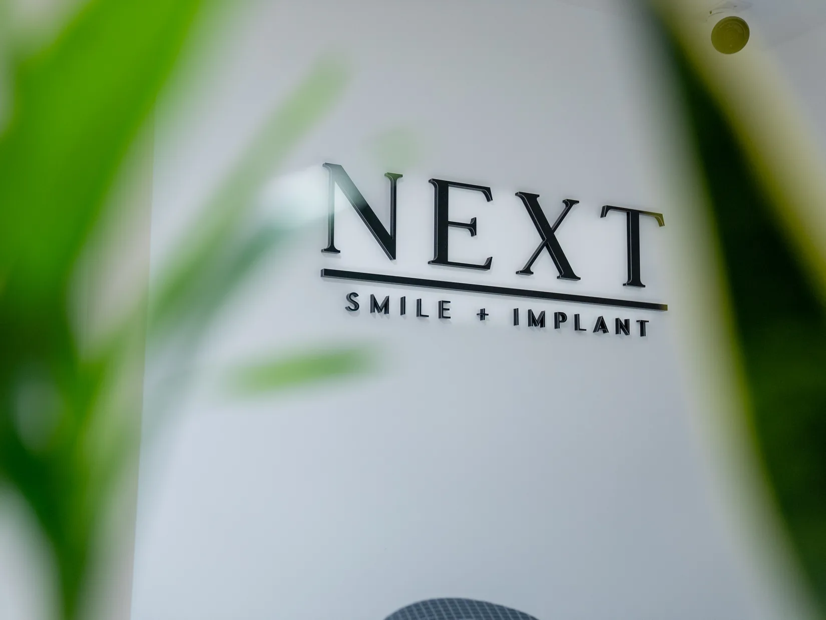 Next Smile+Implant logo wall in the office