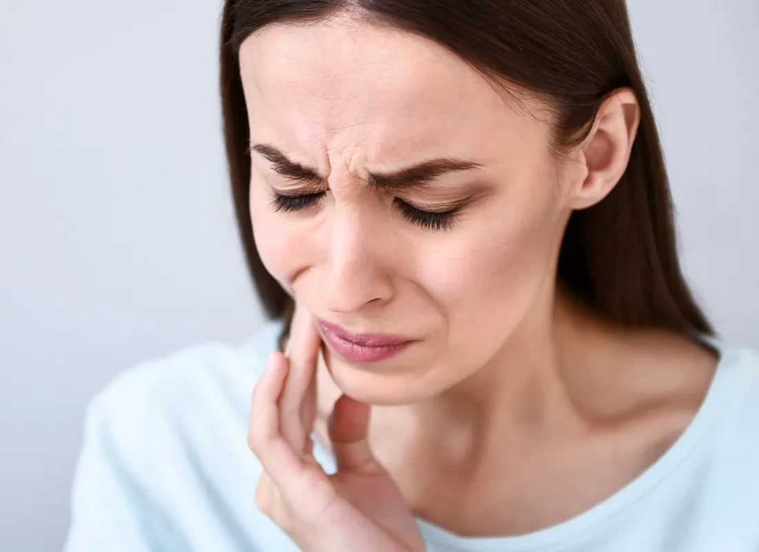 Close-up of a person reacting to a cold drink
